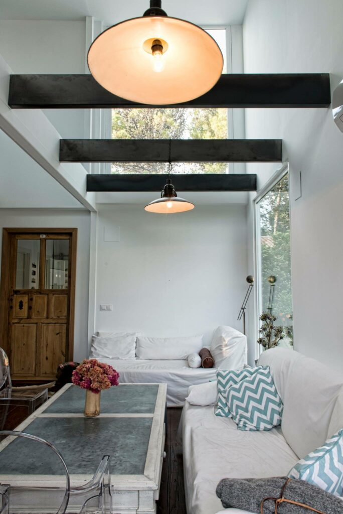 Living room with white couches and wooden center table