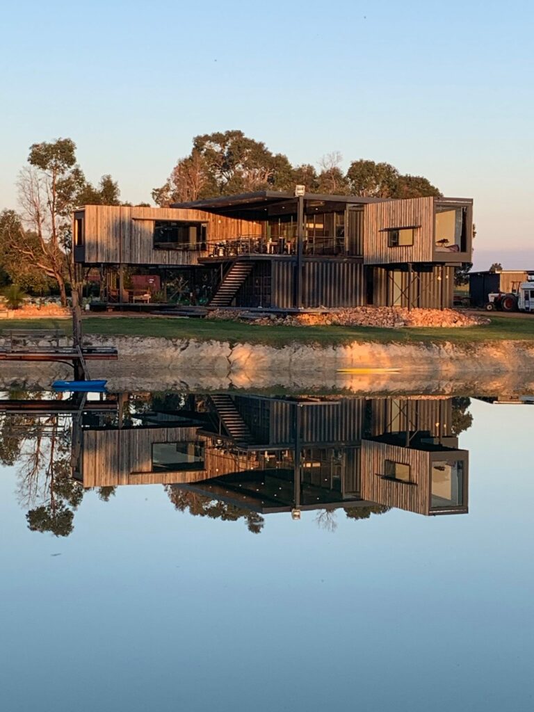 Steve Hick's Stunning Kaloorup Shipping Container House in Western Australia reflected in the lake