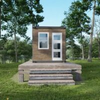 container home in the middle of green grass field