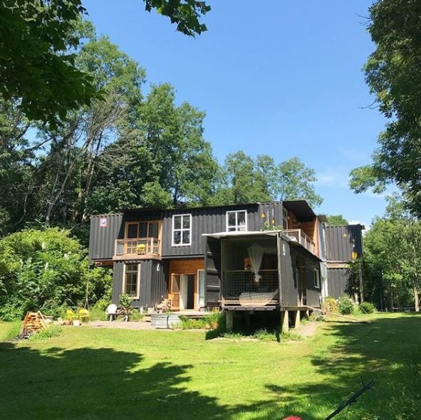 container home in with green lawn