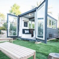 container home on green grass field